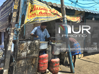 Man selling snacks along the roadside in Kottar, Nagercoil, Tamil Nadu, India on February 12, 2020. (