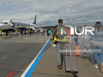Passengers boarding a Ryanair plane at John Paul II Krakow-Balice International Airport.
Ryanair plans to cut another one in five flights sc...