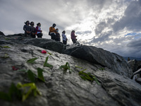 Families of disaster victims sow flowers at the former tsunami site on Talise Beach, Palu, Central Sulawesi Province, Indonesia on September...