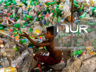 Laborer seen working at a plastic bottle recycling factory in Dhaka, Bangladesh on September 29, 2020. (