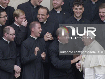 A group of seminarians make the signs of the cross as they are greeted by Pope Francis during his weekly general audience in the St. Damaso...