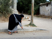 An elderly Palestinian woman walks on the street in Deir al-Balah in the central Gaza Strip October 1, 2020.
 (