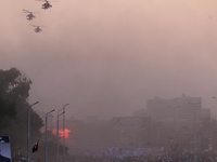 Egyptian military helicopters fly over supporters of Egyptian President Abdel Fattah al-Sisi, held on the occasion the 6th of October war an...