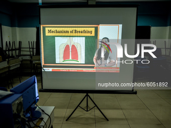 A class lecture is projected on a screen as teachers prepare for the opening of classes at a school in Valenzuela City in Metro Manila, Phil...