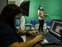 Teachers make use of green screen in filming lectures in preparation for the opening of classes at a school in Valenzuela City in Metro Mani...