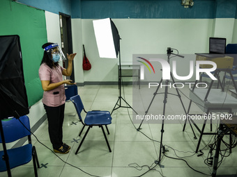 A teacher makes use of green screen in filming lectures in preparation for the opening of classes at a school in Valenzuela City in Metro Ma...