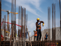 Nepalese workers working at a construction site of new federal parliament building at Singha Durbar, Kathmandu, Nepal on Saturday, October 3...