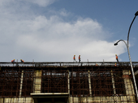 Workers walk on a construction site during coronavirus emergency in Kolkata, India, 03 October, 2020. India's contracting economy reboots fr...