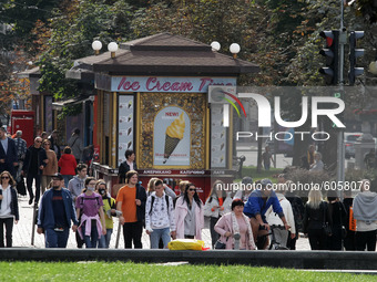 People walk on the warm autumn day along Khreschatyk street in the center of Kyiv, Ukraine on 04 October 2020. (