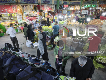 Iranians stand in a bazaar in northern Tehran while the new coronavirus (COVID-19) disease rapid rising in Iran on October 4, 2020. Tehran G...
