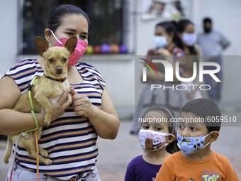 Parishioners take their pets for a blessing on St. Francis of Assisi Day, on October 4, 2020,at St. Julian's Parish in the northern part of...