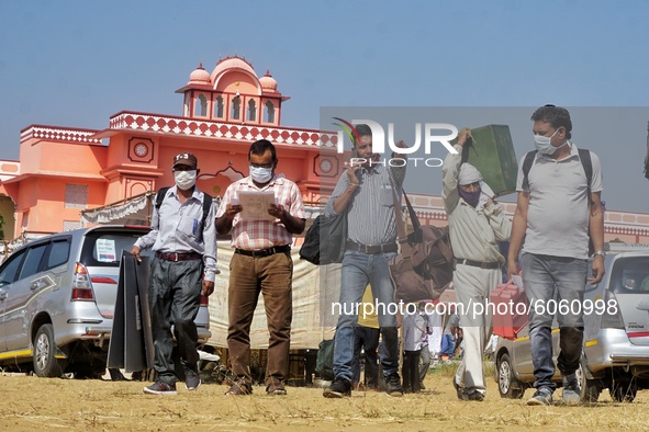 Polling officials carrying EVMs leave ahead of the third phase of Panchayat elections in Rajasthan, at Bhawani Niketan in Jaipur,  on Octobe...