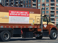 Sign on a garbage truck describing rules to protect sanitation workers from the novel coronavirus (COVID-19) in Toronto, Ontario, Canada on...