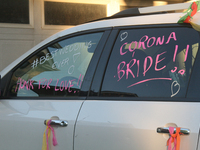 The words 'Corona Bride' written on the wedding car of a newly married Jewish couple in the midst of the coronavirus (COVID-19) pandemic in...