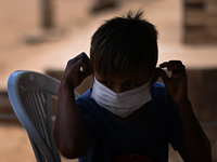 A child from the indigenous Guajajara ethnic group wears a face mask, amid the Coronavirus (COVID-19) pandemic, at the Guajajara indigenous...