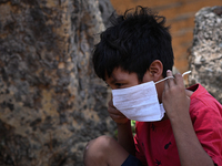 A child from the indigenous Guajajara ethnic group wears a face mask, amid the Coronavirus (COVID-19) pandemic, at the Guajajara indigenous...