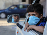 A child mask-clad due to the Covid-19 coronavirus pandemic, looks at the street in Gaza city,on October 8, 2020.
 (