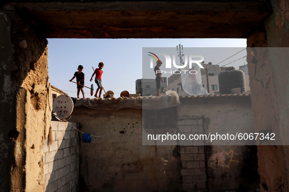 Palestinian children are seen on the roof of their house in Al-Shati refugee camp in Gaza City on October 8, 2020. 