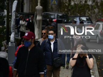 People wearing protective masks walk around the town of SIntra, in Portugal on 8 October 2020. The Secretary of State for Health, Lacerda Sa...