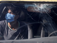 A young Palestinian man looks from behind the windows of a car in Gaza City, on October 8, 2020. (