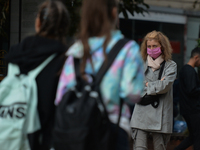 A lady wearing a protective mask seen walking in Vitosha Boulevard, the main commercial street in the centre of Sofia. 
The number of people...