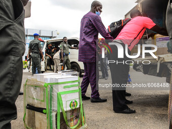 Official of Independent National Electoral Commission moving sensitive electoral materials into a van, which is to distributed to different...
