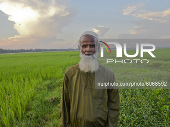 A farmer poses for a picture in a paddy field at Doulatpur Village in Jamalpur District, Bangladesh, on October 8, 2020

 (