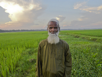 A farmer poses for a picture in a paddy field at Doulatpur Village in Jamalpur District, Bangladesh, on October 8, 2020

 (