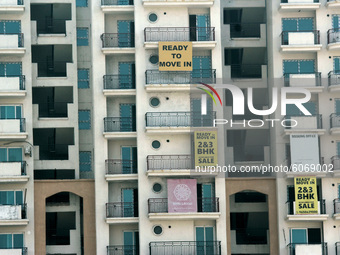 Boards showing 'ready to move in' and ' possession started' for 2-3 BHK flats near Sahibabad to attract investors towards real estate sector...