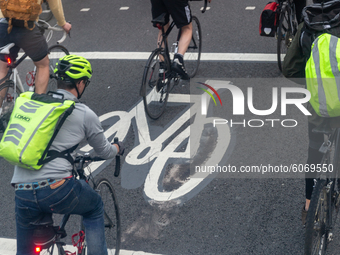Cyclists are seen commuting on a bicycle path as London works towards greener communication system  England on October 8, 2020. (