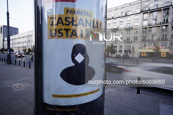A poster urgning people to wear face masks is seen in central Warsaw, Poland on October 8, 2020. The ministry of health on Thursday announce...