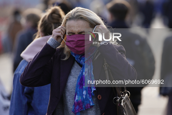 A woman puts on a face mask in central Warsaw, Poland on October 8, 2020. The ministry of health on Thursday announced 4280 new infections o...