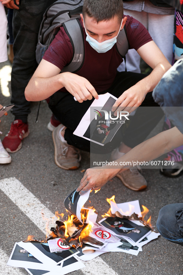 Anti-monarchy demonstrators burn a picture of the Spanish King during a protest against the visit of King Felipe VI of Spain to Catalonia, i...