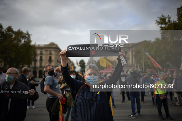 A woman shows a poster with the message ''Catalonia has no king'' during a protest against the visit of King Felipe VI of Spain to Catalonia...