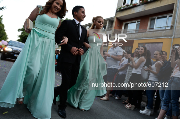 A boy accompanied by two girls is making his way through the crowd of well wishers in the town of Svilengrad, Bulgaria on May 26, 2015 