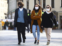 A group of young people is wearing protective face masks during coronavirus pandemic. Krakow, Poland on October 9th, 2020. Due to the increa...
