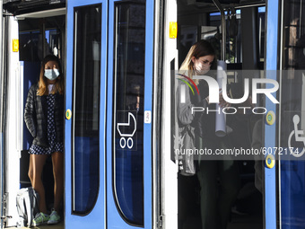 People are wearing protective face masks while commuting on public transport during coronavirus pandemic. Krakow, Poland on October 9th, 202...