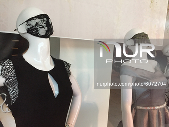 Mannequins wearing face masks in the window of a clothing shop at a shopping mall during the novel coronavirus (COVID-19) pandemic in Toront...