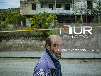 A lonely man walks in the empty streets of Martakert during the clashes between the Nagorno Karabakh and Azerbaijan armies on October 9, 202...