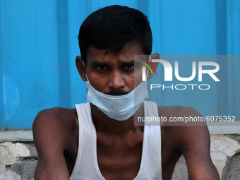 A man with covered face as a precautionary measure against COVID-19, during nasal swab sample collection for corona virus Rapid Antigen Test...
