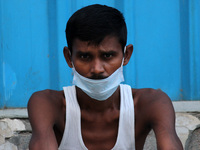 A man with covered face as a precautionary measure against COVID-19, during nasal swab sample collection for corona virus Rapid Antigen Test...
