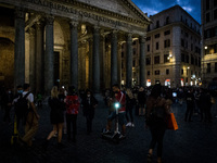 People wearing protective masks walks near Piazza della Rotonda,  in Rome, Italy, on October 10, 2020 amid the COVID-19 pandemic. (