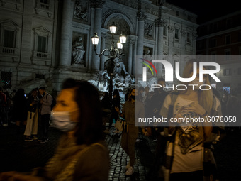 People wearing protective masks are seen near the Trevi Fountain  in Rome, Italy, on October 10, 2020 amid the COVID-19 pandemic. (