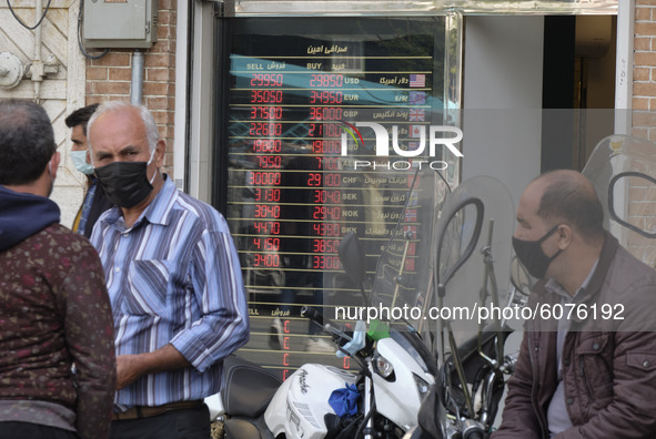 Iranian street money changers stand out of a currency exchange shop in Tehran’s business district on October 10, 2020. U.S. Dollar has risen...