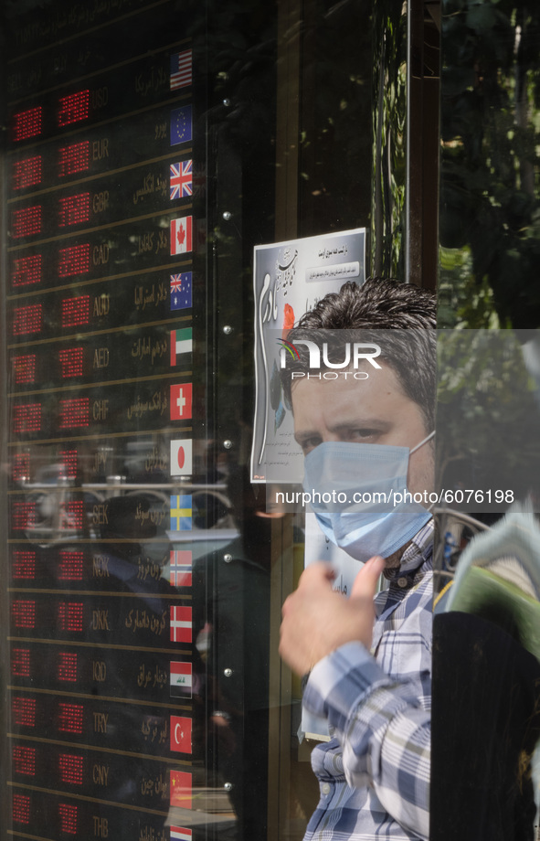An Iranian trader stands at the door of his currency exchange shop in Tehran’s business district on October 10, 2020. U.S. Dollar has risen...