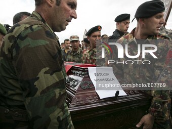 PRISTINA, KOSOVO-- May 26, 2015- KLA  Kovovo Liberation Army  members help bury Fatlum Vishesella, one of eight ethnic Albanian gunman kille...