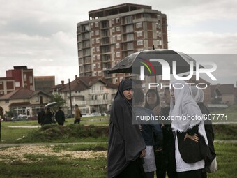 PRISTINA, KOSOVO-- May 26, 2015- Women gather in a field where a  funeral was held for eight ethnic Albanian gunman killed in clashes with p...