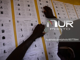 A Voter checks his name on INEC voting list at scared heart primary in schoolGbogi/Isikan, in Akure South Ondo State on October 9, 2020.  (