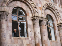 A man stands in a destroyed window of a church after an Azerbaijan shelling over the Martuni village on October 11, 2020. (