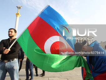 An Azerbaijani man bows before Azerbaijan's flag during a rally in support of Azerbaijan against Armenia in the Nagorno-Karabakh conflict on...